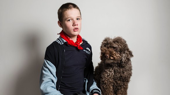Logan, pictured with his therapy dog Simi, has autism and requires one-on-one care at Marymead's respite service.