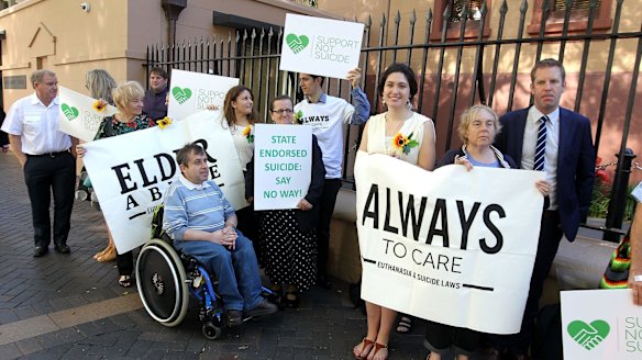 Opponents of the bill standing outside State Parliament on Thursday.
