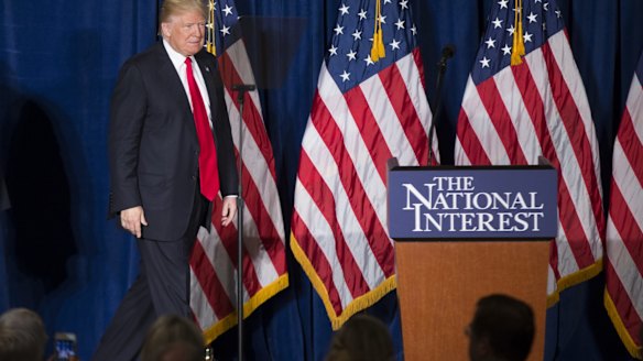 Something wooden in his walk?  Donald Trump approaches the podium to deliver a speech defanged of his usual rhetoric.