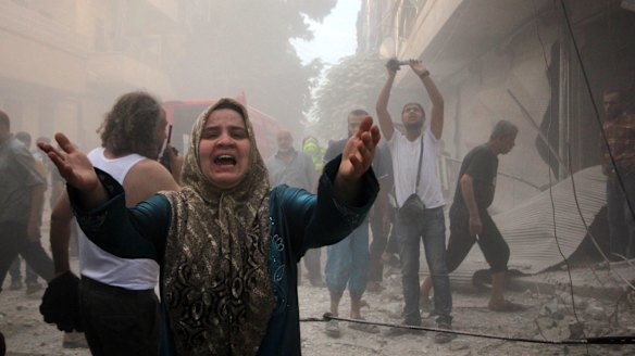 A Syrian woman mourns following an air strike by Assad government forces on the al-Mowasalat neighbourhood of the northern Syrian city of Aleppo on September 20.