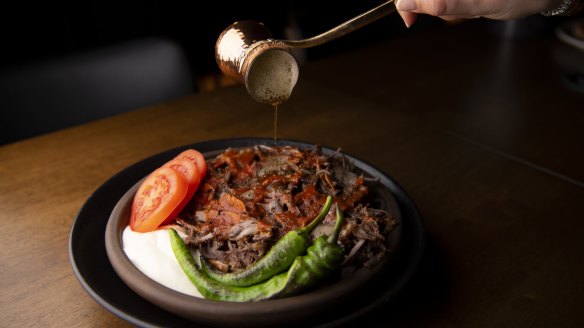 Iskender kebab with tomato, yoghurt and Turkish chilli.