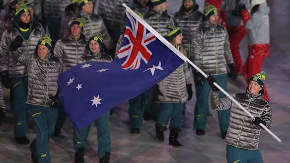 Proud moment: Scotty James carries the Australian flag into the arena.