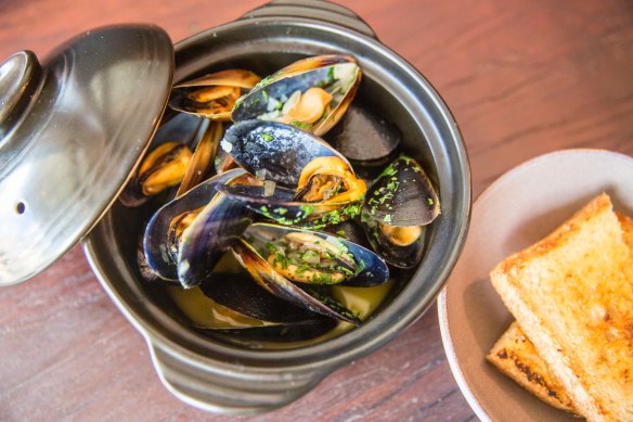 Mussels in white wine demand hot-buttered bread and a glass of something cold.
