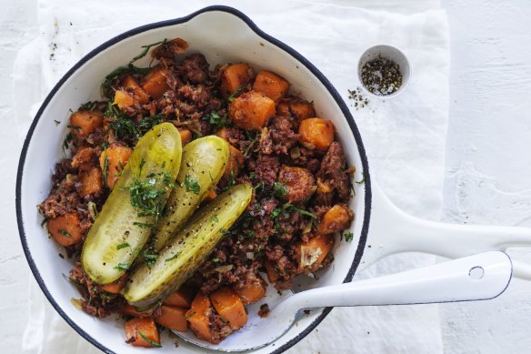 Corned beef and sweet potato hash with American pickles.