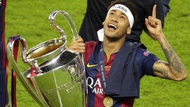Neymar celebrates with the Champions League trophy after the final between Juventus and Barcelona at the Olympic stadium in Berlin in 2015.