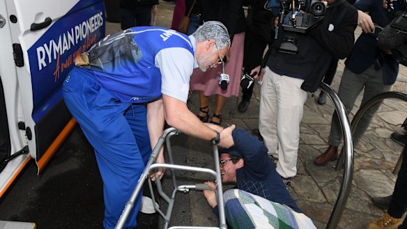 Patrick Dangerfield assists Isaac Smith after he 'fell' off the bus