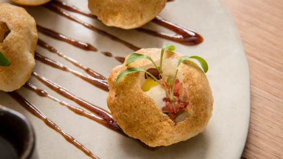 Pani puri - crisp semolina puff with sprouts, finger lime and mint water.