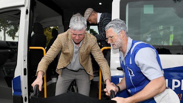 Patrick Dangerfield helps Mitch Duncan off the bus
