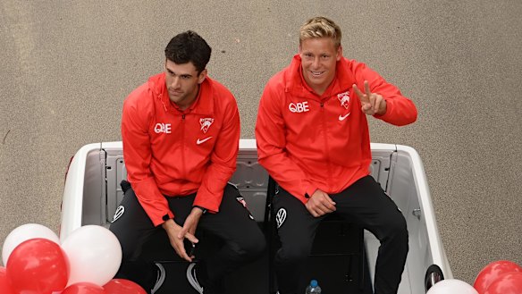 Robbie Fox and Issac Heeney of the Sydney Swans wave to fans during the AFL Grand Final parade