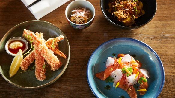 Food is designed to share, such as (clockwise from top right) kimchi and seafood dumplings, salmon with pickled fennel and radish, and prawns with iburi gakko and tartare.