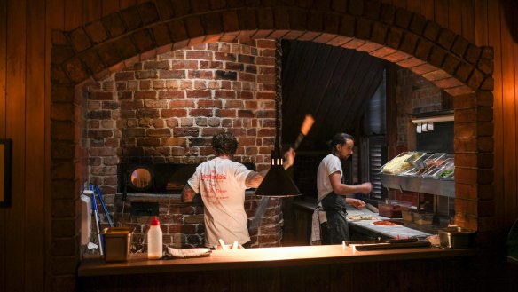 A brick arch frames the pizza oven.