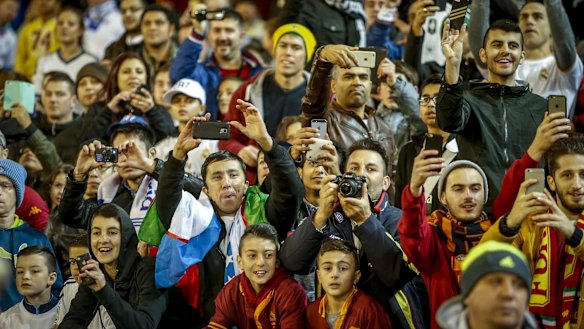Soccer fans try to catch a glimpse of the stars.