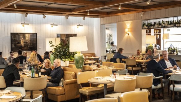 Fawn lounges and lamps feature in the light-filled dining room.