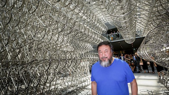 Ai Wei Wei under his bicycle sculpture at the NGV.