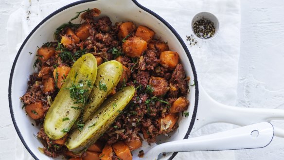 Corned beef and sweet potato hash with American pickles.