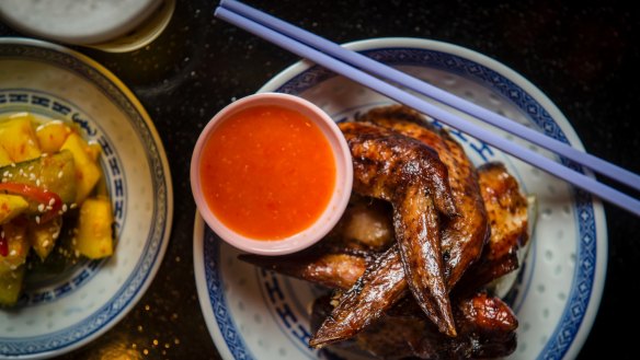 Barbecue wings with chilli vinegar and lime (right) and cucumber salad. 