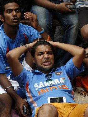 Indian fans watch the Cricket World Cup semi-final on television in Mumbai. 