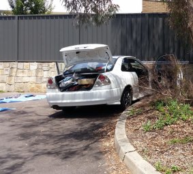 Detectives removed items, including a baseball bat, from a white car parked in a corner of the nearby Noah's Ark Family and Community Centre carpark.