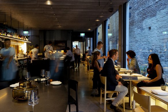 New laneway spot Beau Bar is a moody, shadowy space built around a swish black granite island bar.