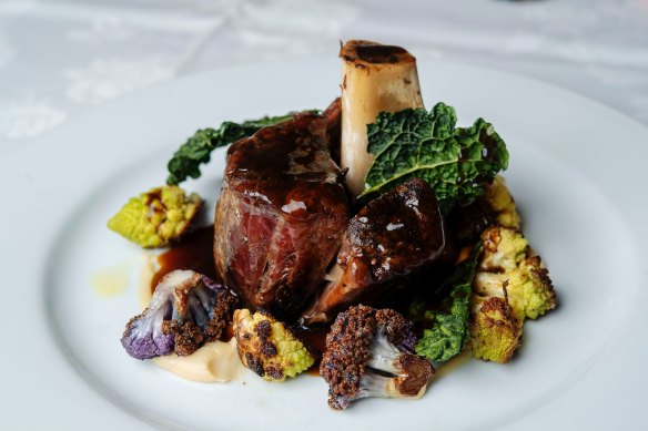 Braised venison shank on cauliflower puree, romanesco and Tuscan kale.