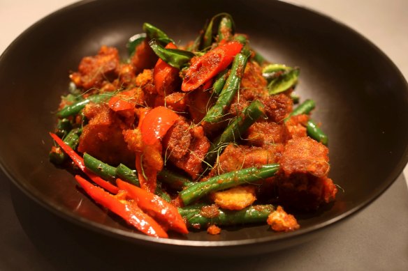 Must-try: Wok-fried pork belly with red curry paste, beans and kaffir lime leaf.