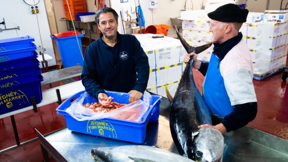 Costa Nemitsas (left), general manager of Martin's Seafood, at his Botany headquarters with Clarence River prawns and yellowfin tuna.