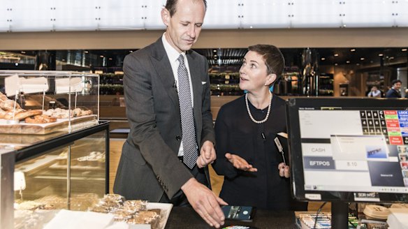 ANZ Bank chief executive Shayne Elliott tries out Android Pay, alongside general manager of deposits and payments, Katherine Bray.
