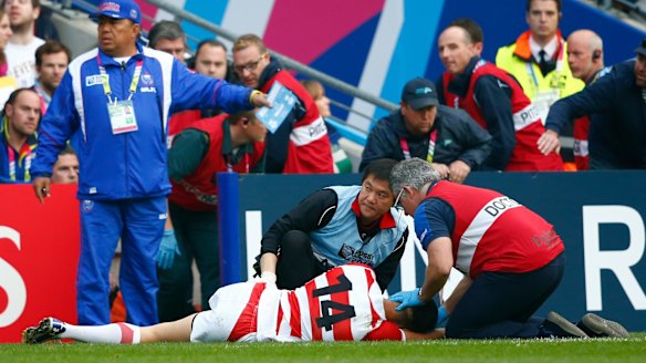 Yamada receives treatment after a heavy knock in the second half.  