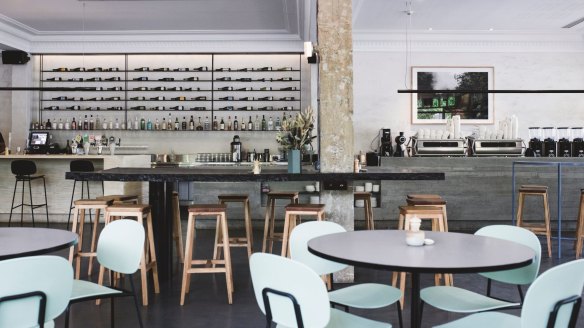 Booth tables carved out of waves of layered pale timber are a lovely feature in the airy, high-ceilinged space that has emerged from a comprehensive remodelling.