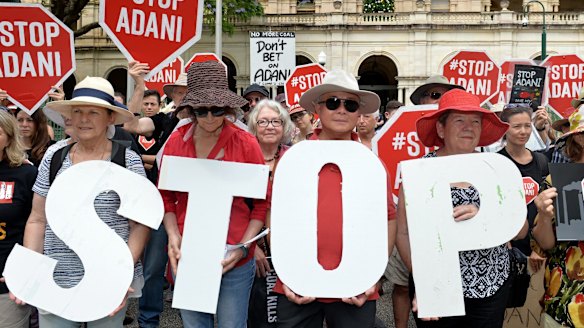 Adani protestors are seen protesting outside of Queensland's Parliament House in Brisbane.