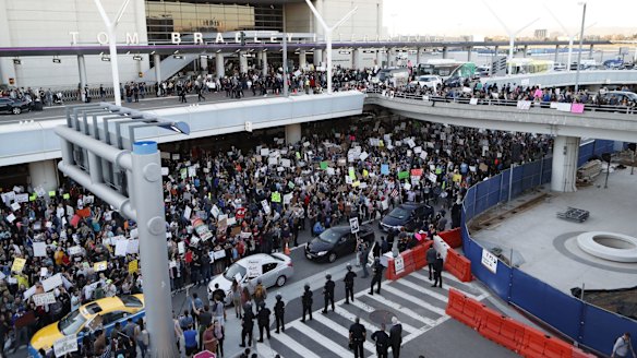 Demonstrators gather the LAX during a protest against President Donald Trump's travel ban on refugees and citizens of seven Muslim-majority nations, on Sunday.