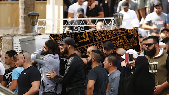 Relatives and friends of Safwan Charbaji, who was shot dead in Condell Park, carry his coffin outside Lakemba Mosque.