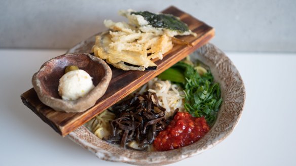 Vegan ramen is dressed up with a bridge over a rugged bowl.