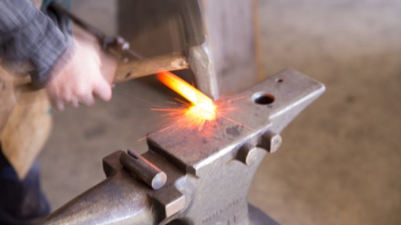 Bladesmith Adam Fromholtz forging a blade at Tharwa Valley Forge.