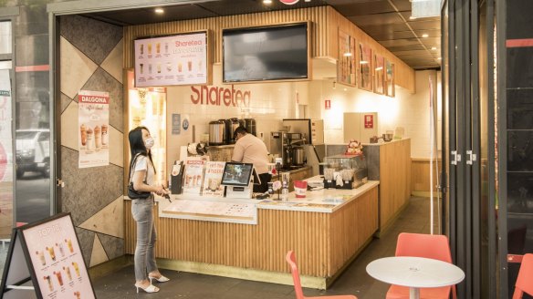 A customer waits for her bubble tea in Sydney's Chinatown.