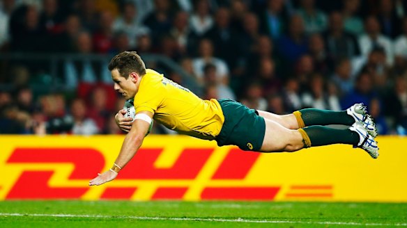 Striking a blow: Bernard Foley goes over to score Australia's second try.