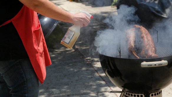 Ribs are sprayed to keep them moist as they cook.