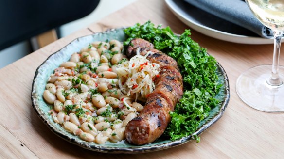 Go-to dish: Spiced pork sausage, kale, cannellini beans, daikon, criolls. 