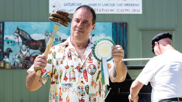 Snag judge Paul Mercurio with the Golden Sausage rosette.