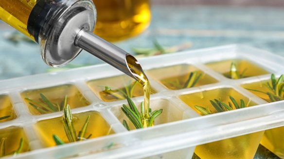 Save your herbs by freezing them in ice cube trays covered in oil.