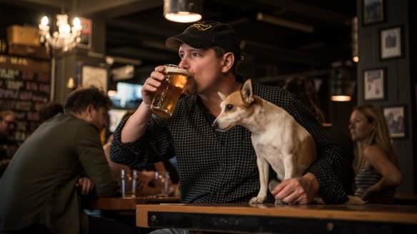 Wayward Brewing Co founder Peter Philip enjoys a pint with Quila the Jack Russell.