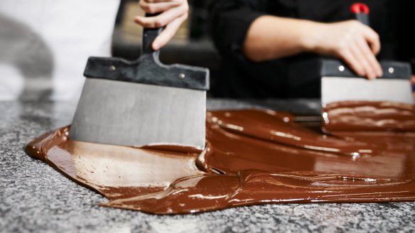 Tempering chocolate on a benchtop.