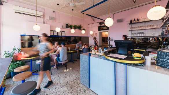 Slider Diner's interior features bright pastels, touches of brass and terrazzo.