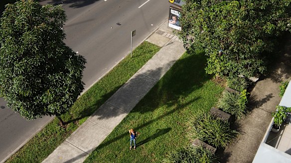 Carmel Deprat, a resident of Euston Road in Alexandria, stands where the road is soon be widened from four lanes to seven. That will mean a lane coming right up to the footpath of her unit block. 