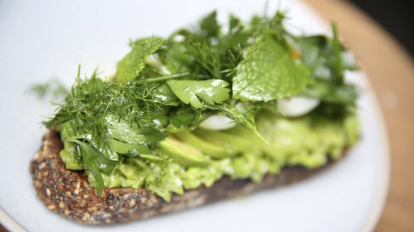 Avocado on toast with softly-set egg, crushed peas and herbs.