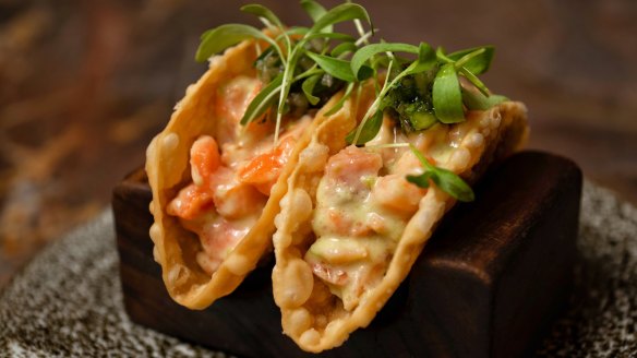 Confit salmon tacos with house-made shells filled with a bright mix of fish, herbs and jalapeno dressing. 
