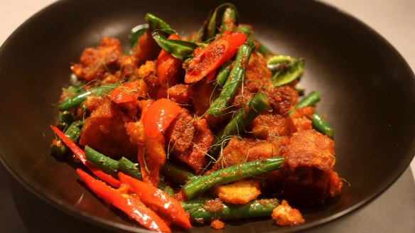 Must-try: Wok-fried pork belly with red curry paste, beans and kaffir lime leaf.