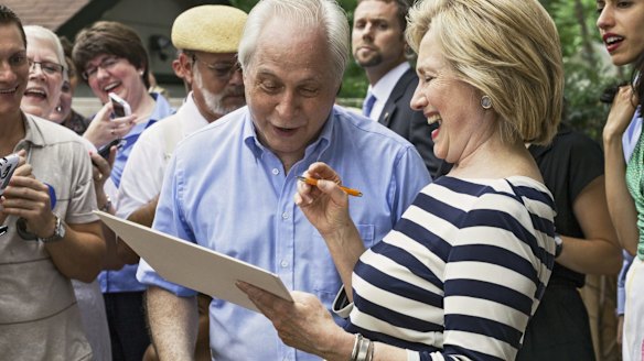 Democratic US presidential candidate Hillary Clinton signs autographs after she spoke at the home of Sean and Vidyha Bagniewski in the Beaverdale area of Des Moines, Iowa.
