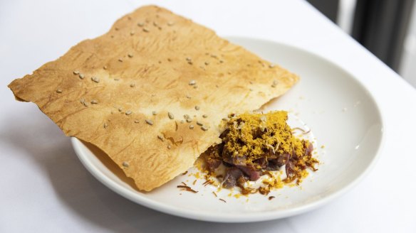Venison tartare with anchovy cream and a sunflower seed cracker.