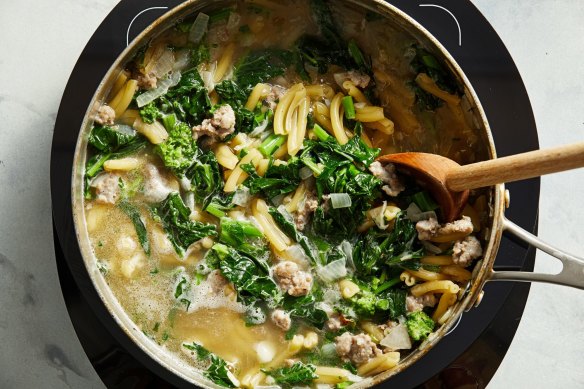 One-pot pasta in progress, with sausage chunks and broccolini.